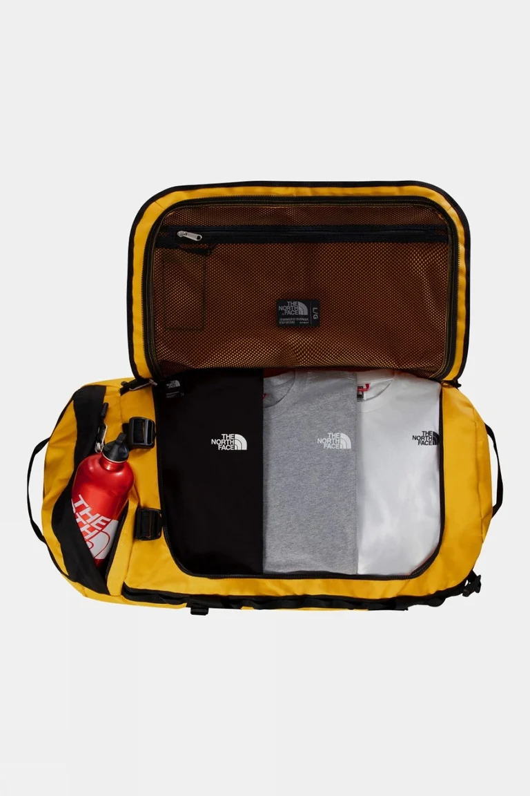Summit Gold The North Face Base Camp Duffel Large opened wide with folded clothing and a bottle packed inside